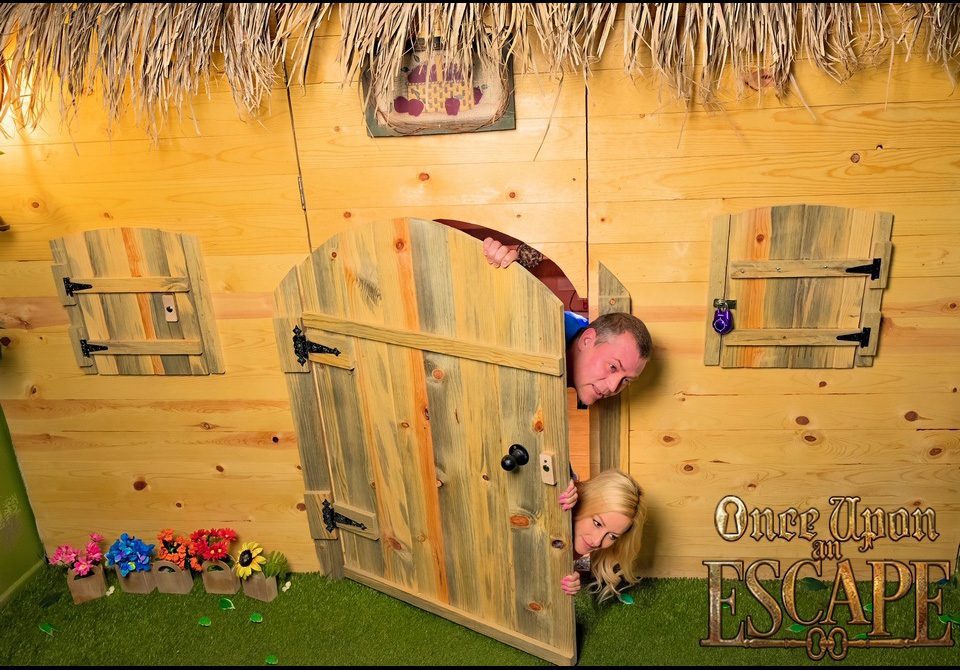 Once Upon an Escape - Kendra and Justice peeking out from behind a fairytale door