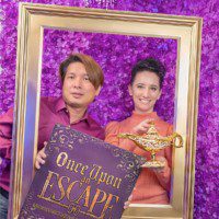 Once Upon an Escape - Couple within a picture frame holding a magic genie's lamp