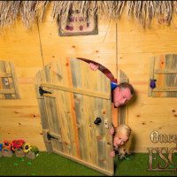 Once Upon an Escape - Kendra and Justice peeking out from behind a fairytale door